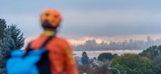 Photo of person where bike helmet looking with a view of the city