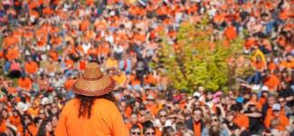 A group of people in orange shirts