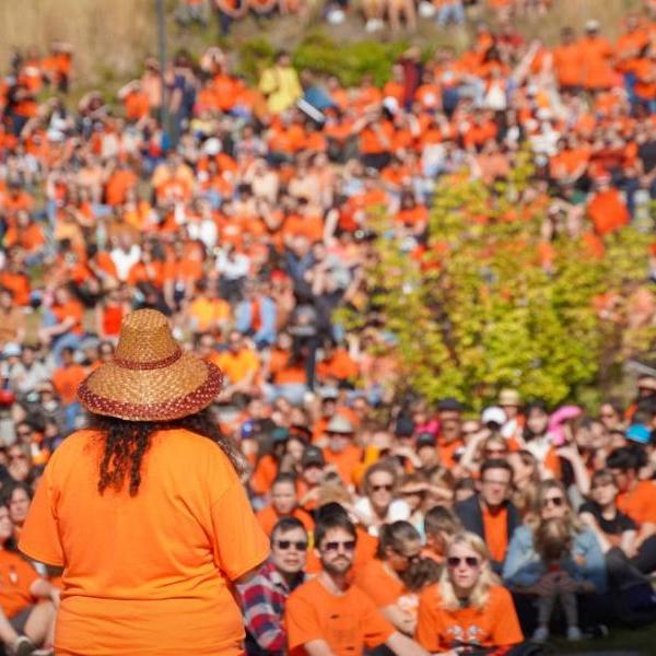 A group of people in orange shirts