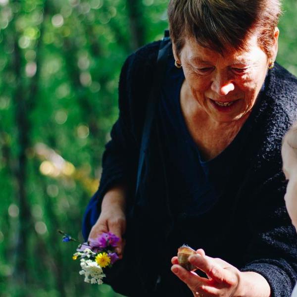 Image of woman showing flowers to a child